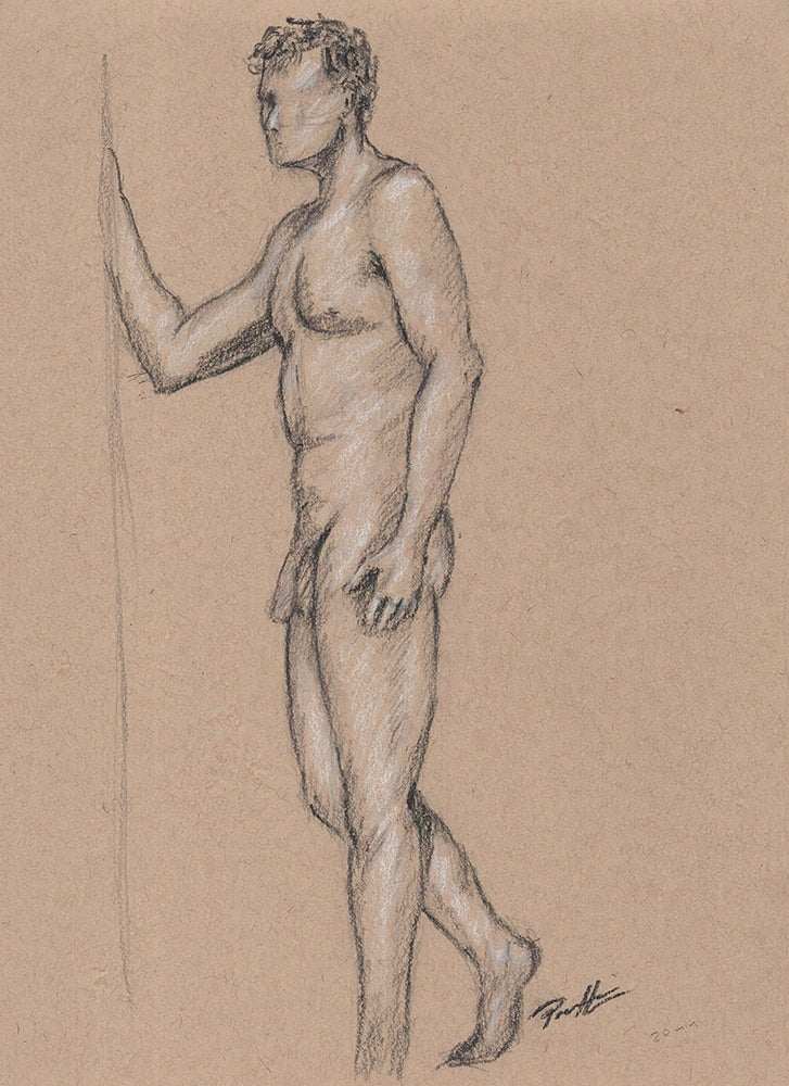 One of a kind original on toned paper of a nude male figure drawing from a live model using black and white charcoal. The male is standing, resting a hand on the wall.